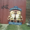 Laughing Lions with sign, pine and polychrome (1968)